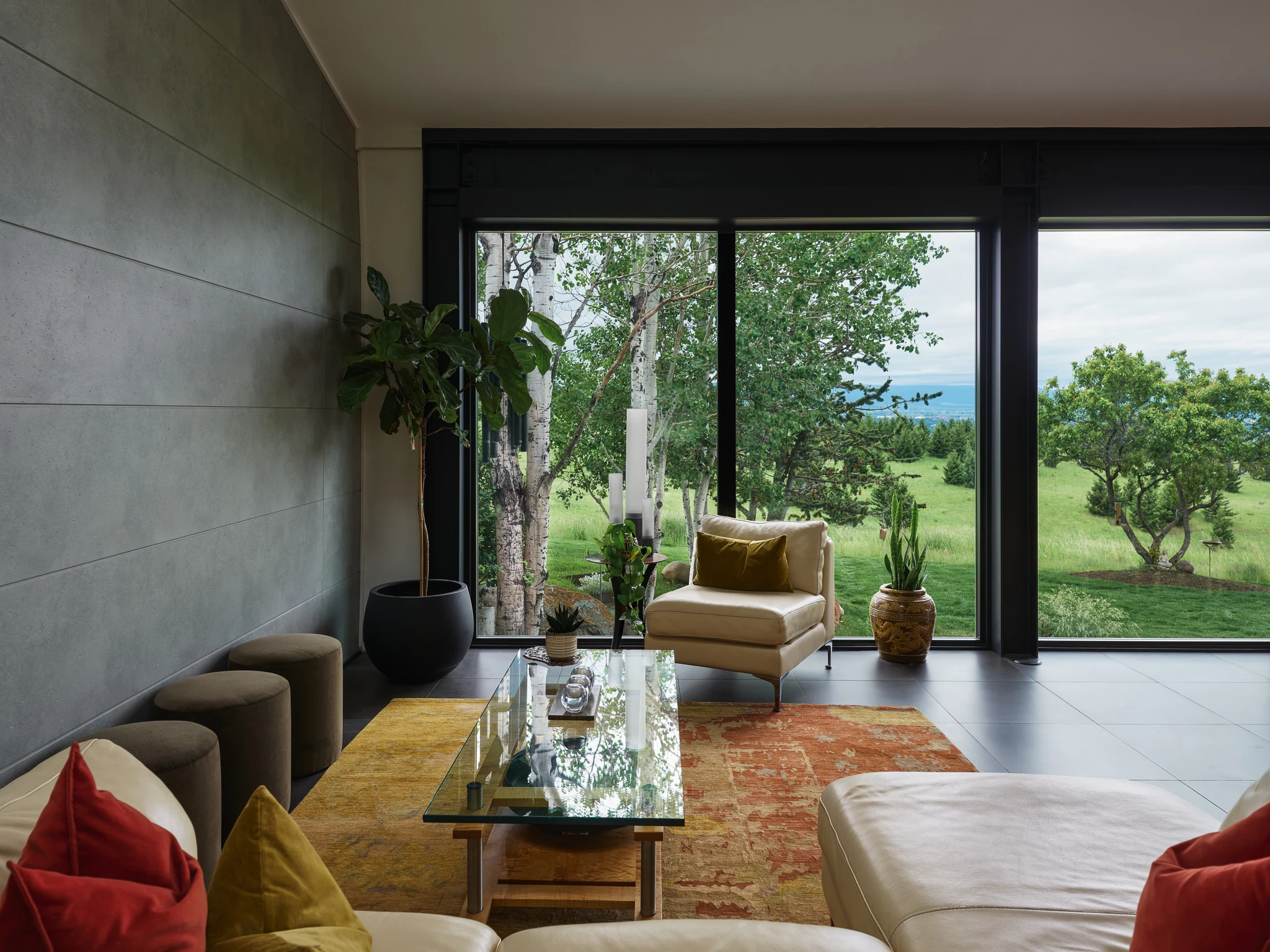 Living room with a glass wall framing aspens and the valley beyond — architectural photography Bozeman Montana, Bozeman Overlook